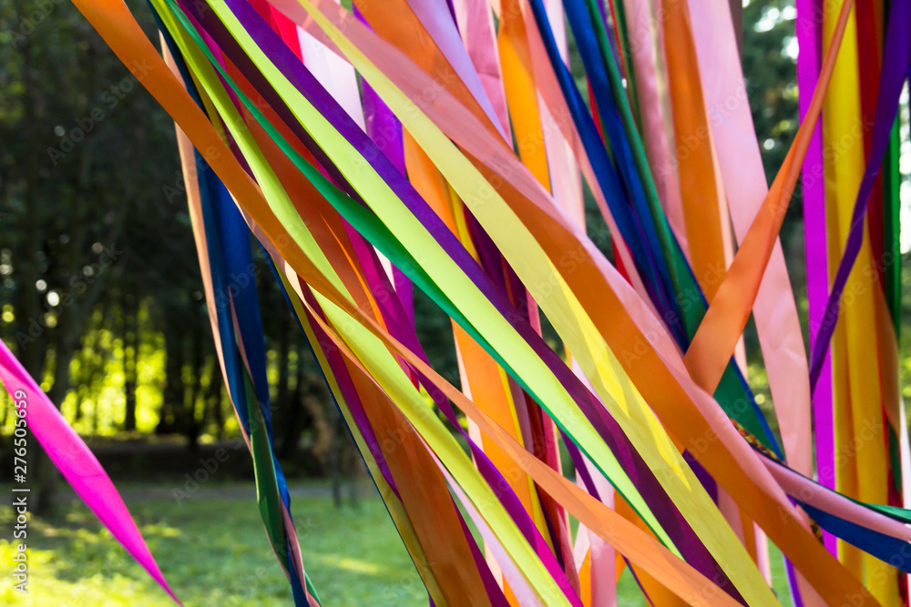 Ribbons are multicolored fabric in the wind in the light of the sun.