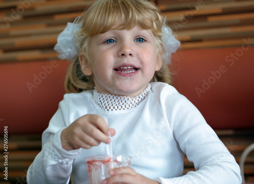 Little girl eating ice-cream and talking