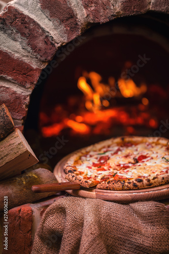 tasty pizza out of oven in restaurant kitchen