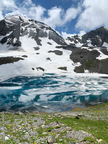 Russia, North Ossetia. Mountain lake Dzedo East (Zrug, Zrugskoye, Zrugskoe) in  cloudy July day photo