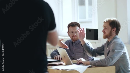 Wallpaper Mural Happy relaxed young male boss businessman talking to smiling colleagues at modern loft office workplace table. Torontodigital.ca