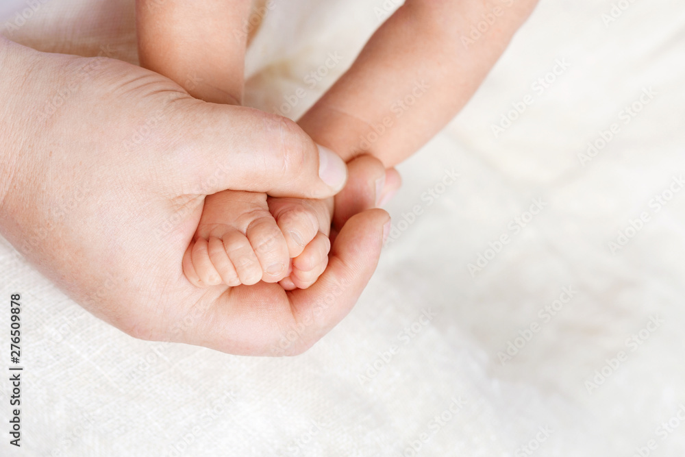  Newborn baby feet in father hands. Father holding legs of the kid in hands. Close up image.  Beautiful conceptual image of parenthood - obrazy, fototapety, plakaty 