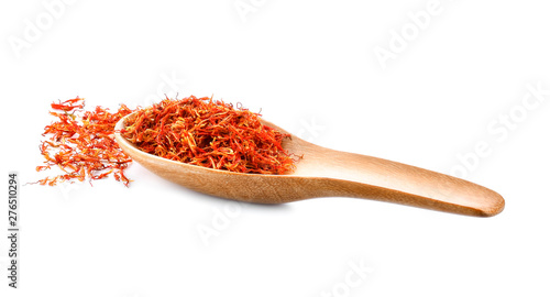 Safflower dried in wood spoon on white background