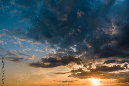 Beautiful colorful sunset with cumulus clouds with bird. © Aleksandra Abramova