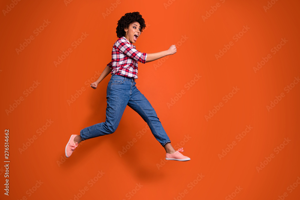 Full body side photo of excited jumping high lady yelling loud sale discount shopping wear casual clothes outfit isolated orange background