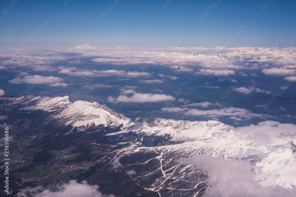 Fototapeta premium Aerial view of snow covered Alps mountains with the Mont-blanc mountain on the background. France 2019.
