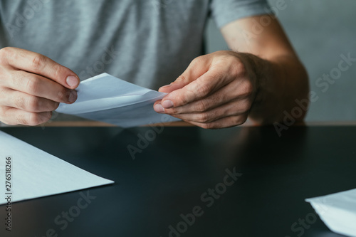 Resignation notice. Cropped shot of man inserting formal letter into envelope. Copy space.