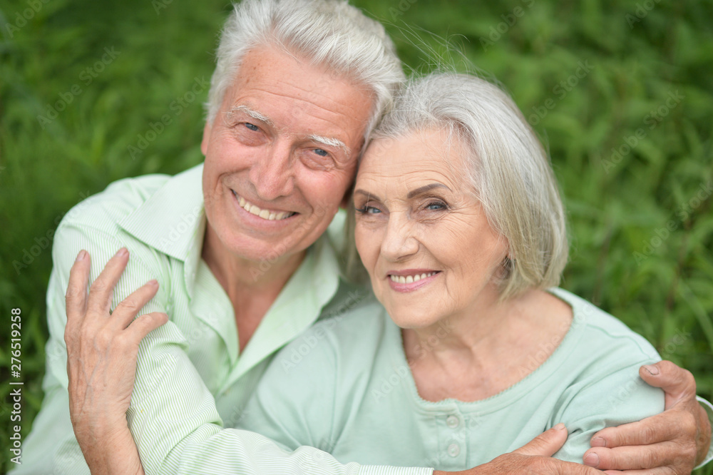 Beautiful senior couple posing in the park Beautiful senior couple posing in the park