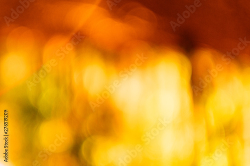 Red and yellow blur lens flare. Defocused golden glow effect. Abstract art background.