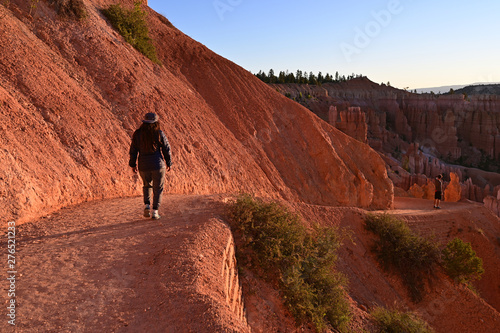 Young woman hiking the Navajo Loop Trail in Bryce Canyon National Park, Utah at sunrise.