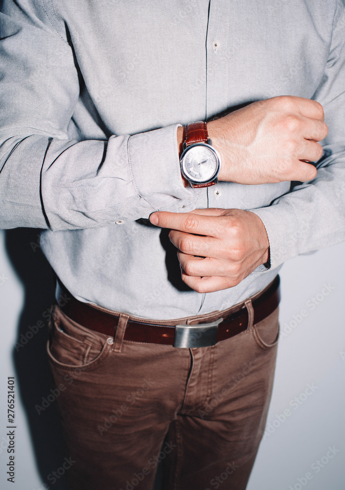closeup fashion image of luxury watch on wrist of man.body detail of a business man.Man's hand in a checkered with cufflinks in jacket pocket closeup. Tonal correction closeup fashion image of luxury watch on wrist of man.body detail of a business man.Man's hand in a checkered with cufflinks in jacket pocket closeup. Tonal correction