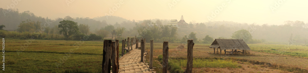 Obraz premium panoramic views of traditional farm land and crops spreading out into the distant mountains of Northern Thailand, Southeast Asia
