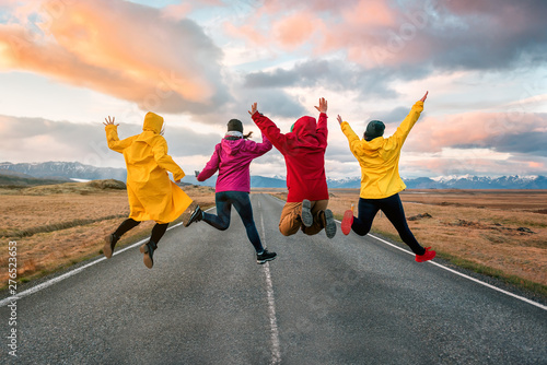 four friend jump on the road at sunset photo