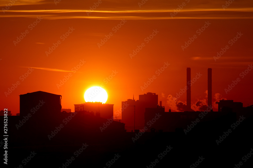 silhouette of city at sunrise