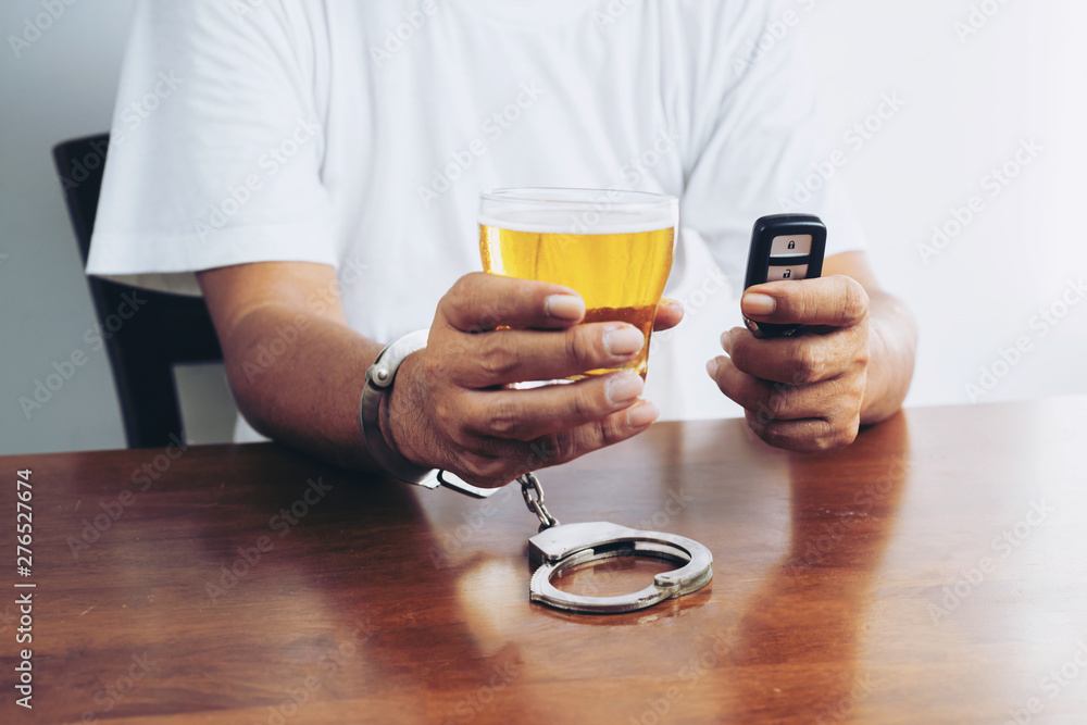 Do not drink and drive! Cropped image of man showing stop gesture and refusing to drink beer. Car keys lying near .Don't drink and drive concept Do not drink and drive! Cropped image of man showing stop gesture and refusing to drink beer. Car keys lying near .Don't drink and drive concept