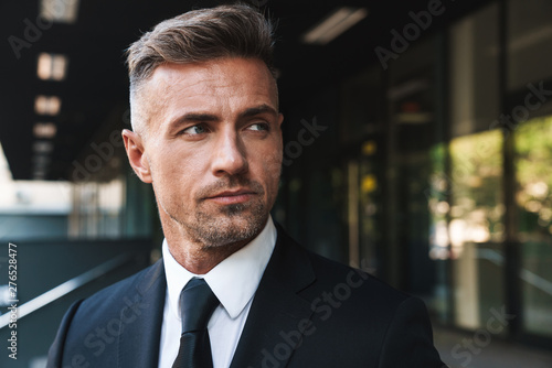 Portrait closeup of handsome businessman standing outside job center during working meeting