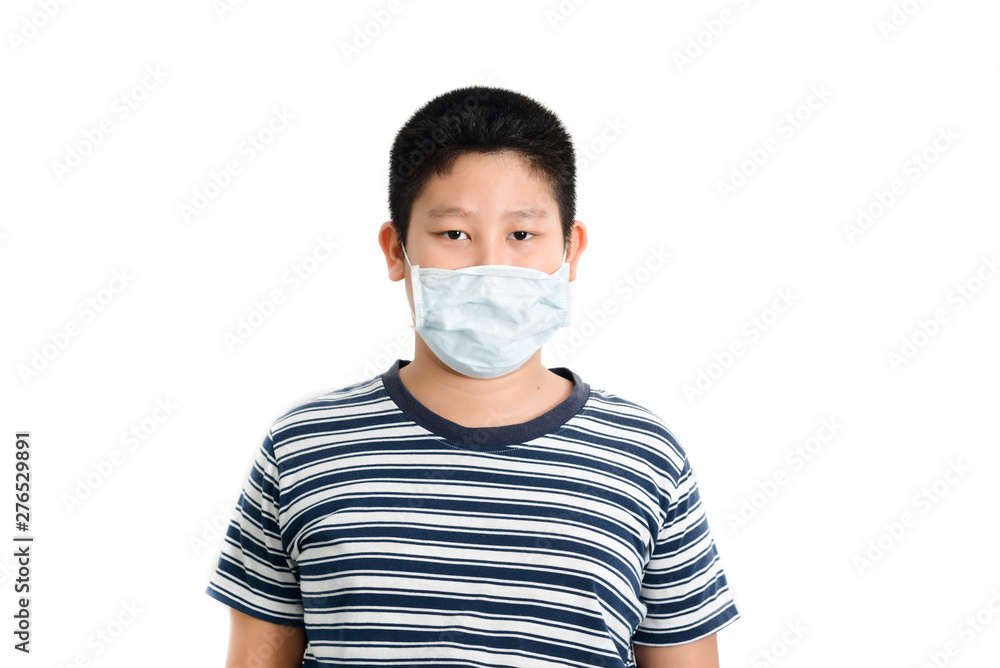 Young Asian preteen boy wearing mask over white background.