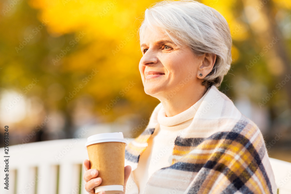 old age, retirement and people concept - portrait of senior woman drinking takeaway coffee at autumn park old age, retirement and people concept - portrait of senior woman drinking takeaway coffee at autumn park