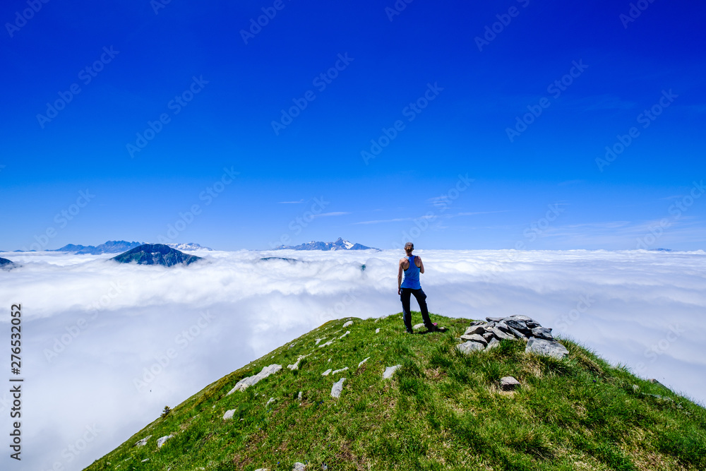 Above the clouds in the mountains of Oisans, Ecrins National Park, French Alps.