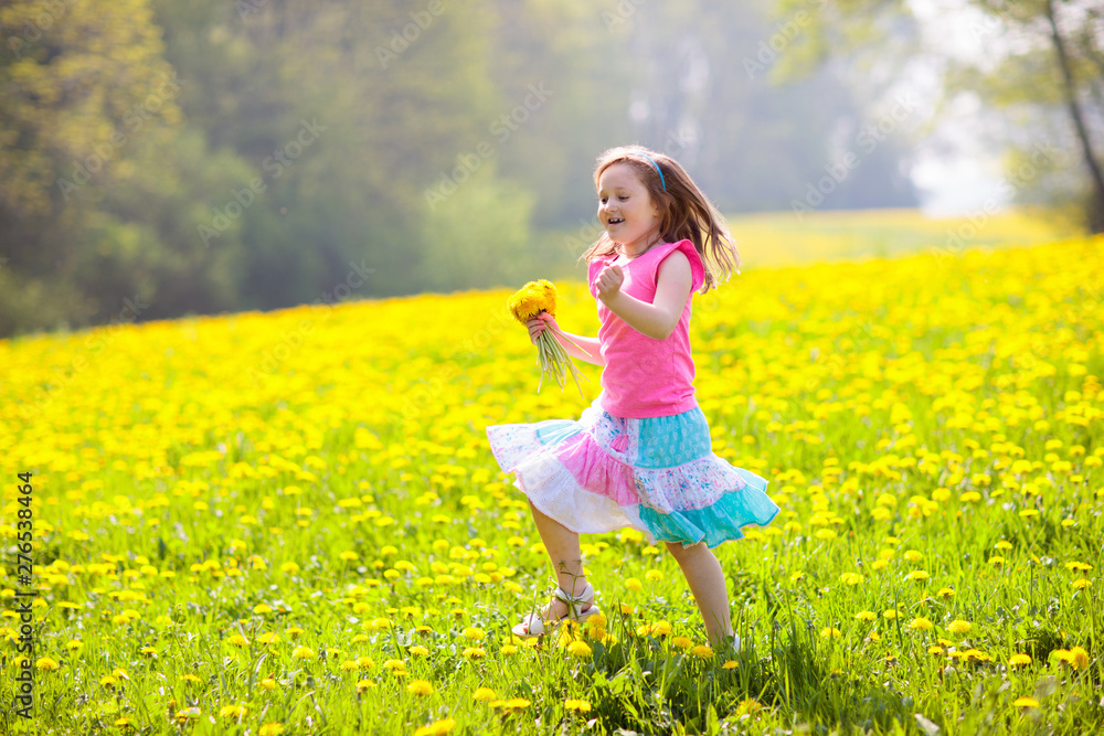 Kids play. Child in dandelion field. Summer flower Kids play. Child in dandelion field. Summer flower
