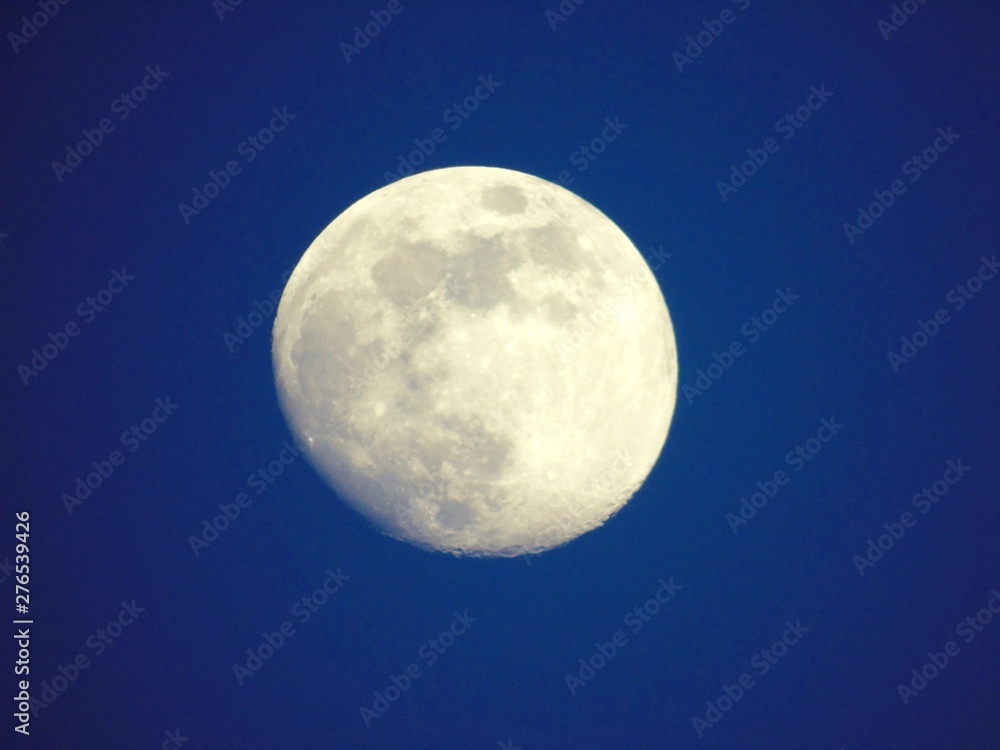An amazing photography of the full moon over the city of Genova by night with a great clear and blue sky in the background and some stars. An amazing photography of the full moon over the city of Genova by night with a great clear and blue sky in the background and some stars.