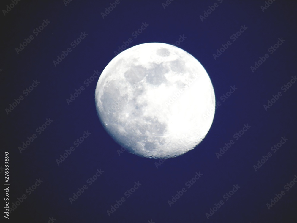 An amazing photography of the full moon over the city of Genova by night with a great clear and blue sky in the background and some stars. An amazing photography of the full moon over the city of Genova by night with a great clear and blue sky in the background and some stars.