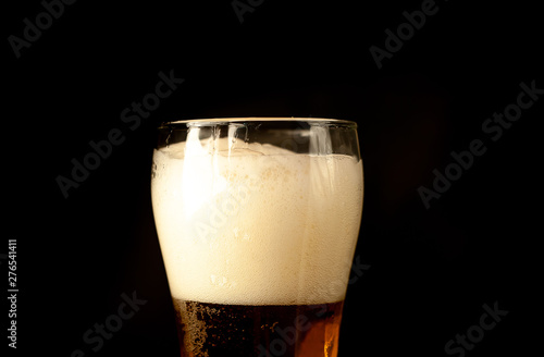 beer glass of fresh, tasty beer on a dark background