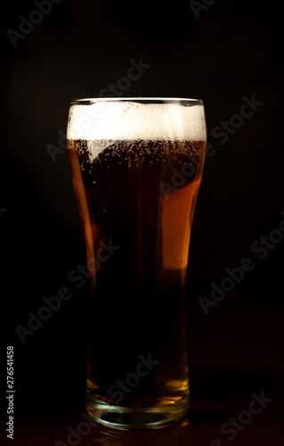 beer glass of fresh, tasty beer on a dark background