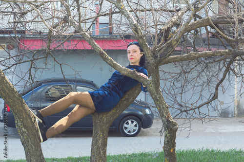 Woman lying on a tree.