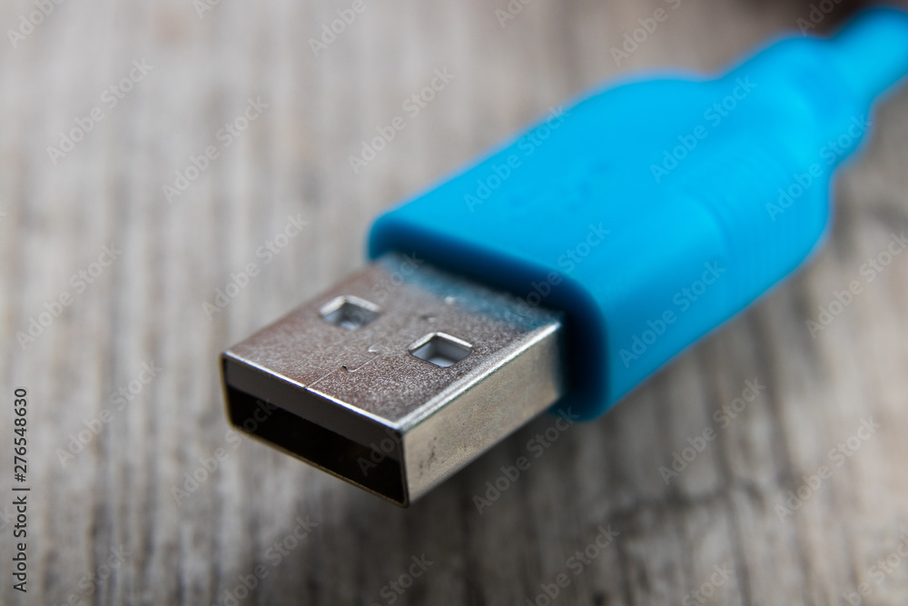 blue usb cable on a wooden board blue usb cable on a wooden board
