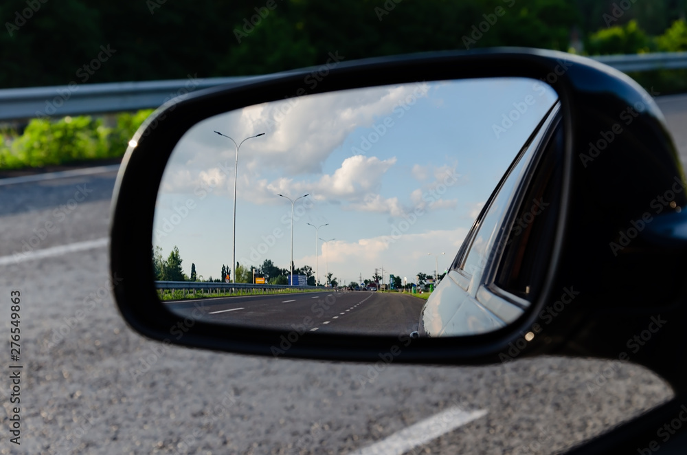 car mirror with motorway reflection