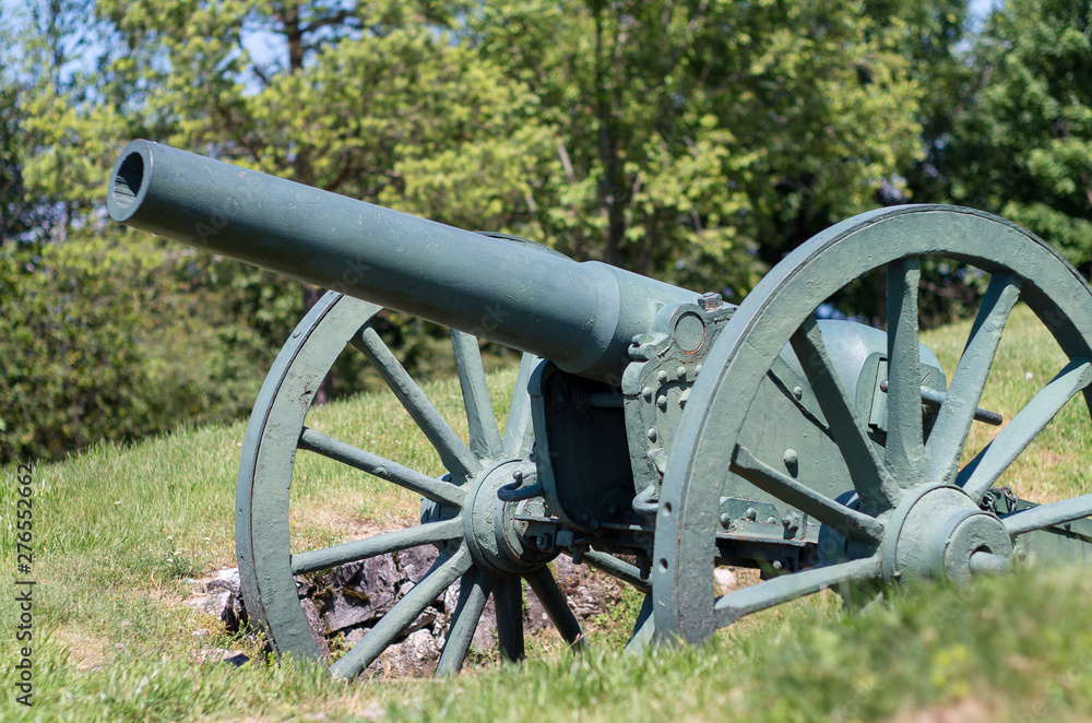 Old metal cannon. Shipka, Gabrovo, Bulgaria. The Shipka Memorial is situated on the peak of Shipka in the Balkan Mountains near Kazanlak, Bulgaria. Old metal cannons against blue sky with clouds.