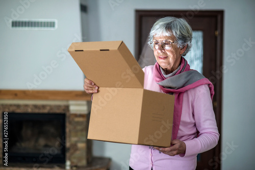 Elder lady opening a delivery box
