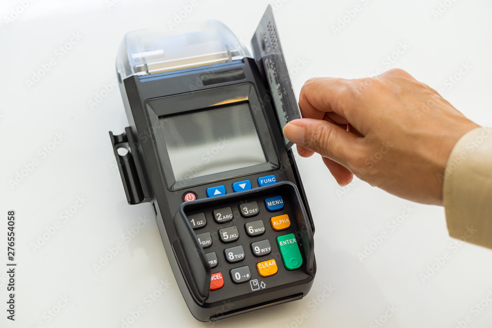 Closeup moment of payment with a credit card machine. Cashless paying for shopping concept. Buy and sell products & service concept Closeup moment of payment with a credit card machine. Cashless paying for shopping concept. Buy and sell products & service concept