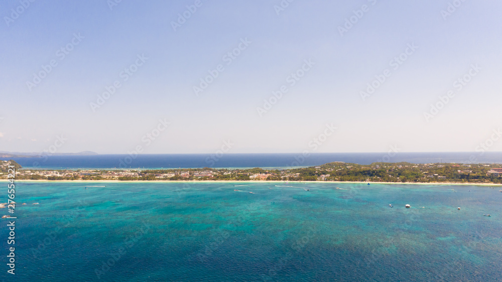 Sulu Sea, view of the island of Boracay, Philippines. Seascape, blue sea and a large densely populated island, aerial view.