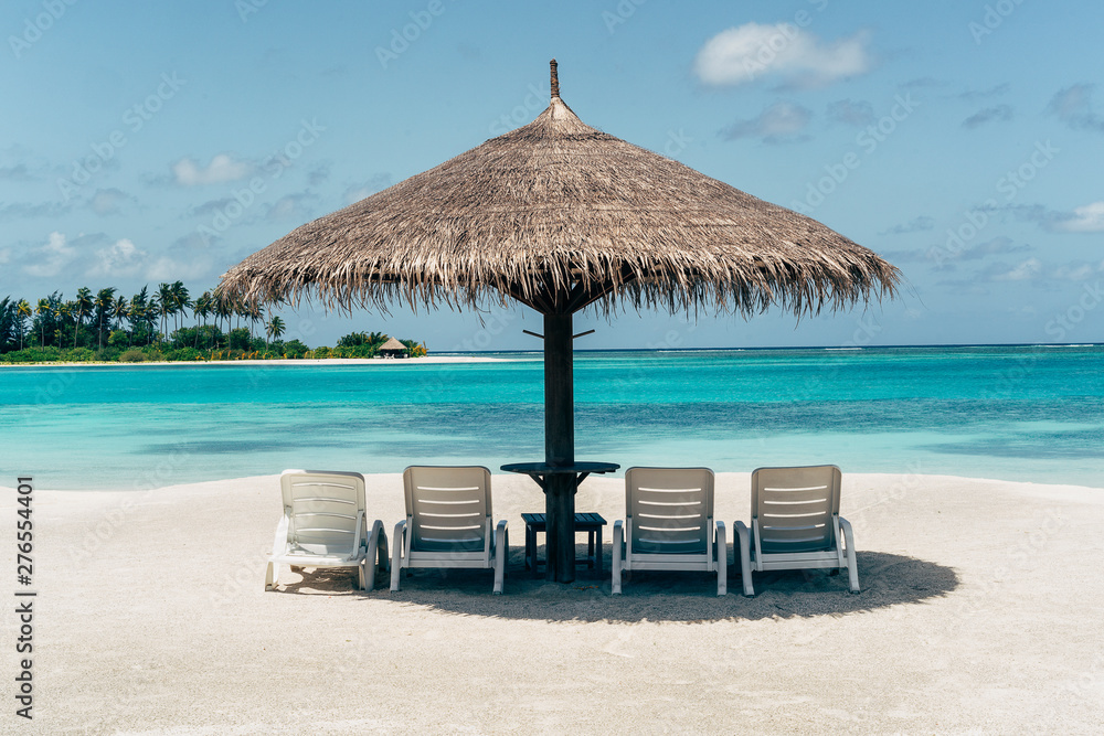 Caribbean paradise beach with umbrella and hammocks