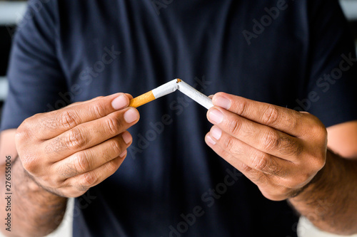 Male hand crushing cigarette. Stop smoking concept