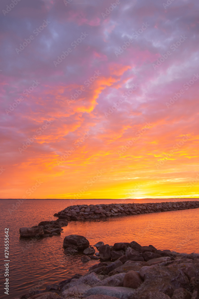 Portrait image on beautiful summer sunrise  by the sea and colorfull cloudy sky.
