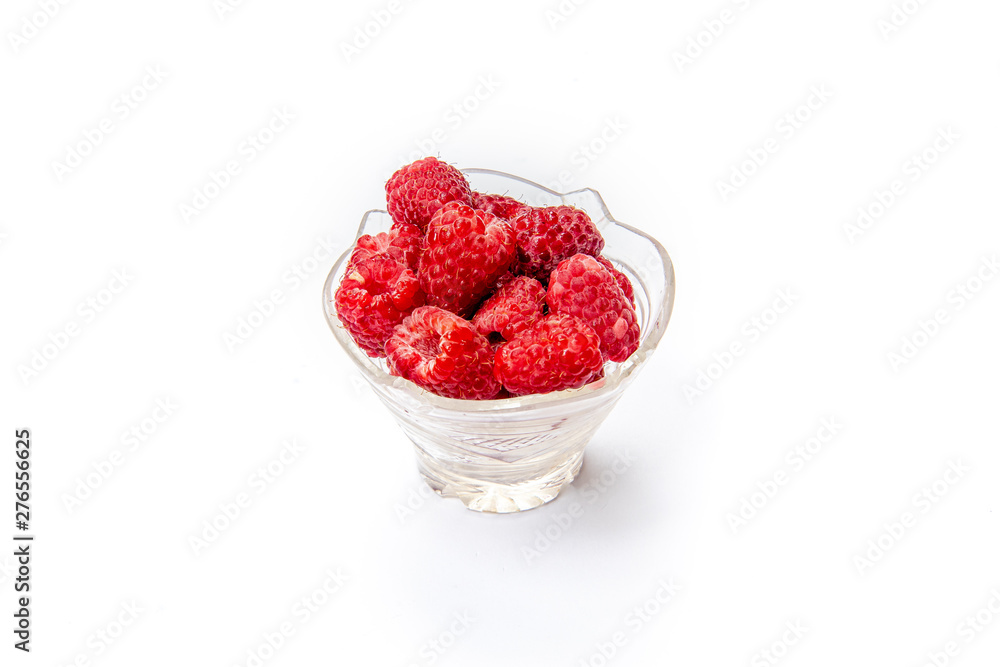 Raspberries in a glass plate on a white background. Isolated Raspberries in a glass plate on a white background. Isolated