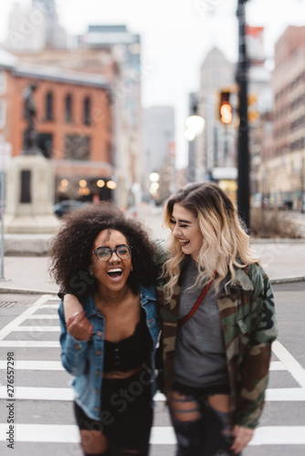 Two female friends walking in the city