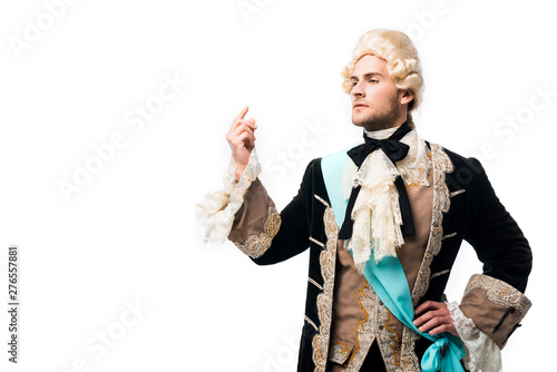 pompous victorian gentleman in wig standing with hand on hip and gesturing isolated on white