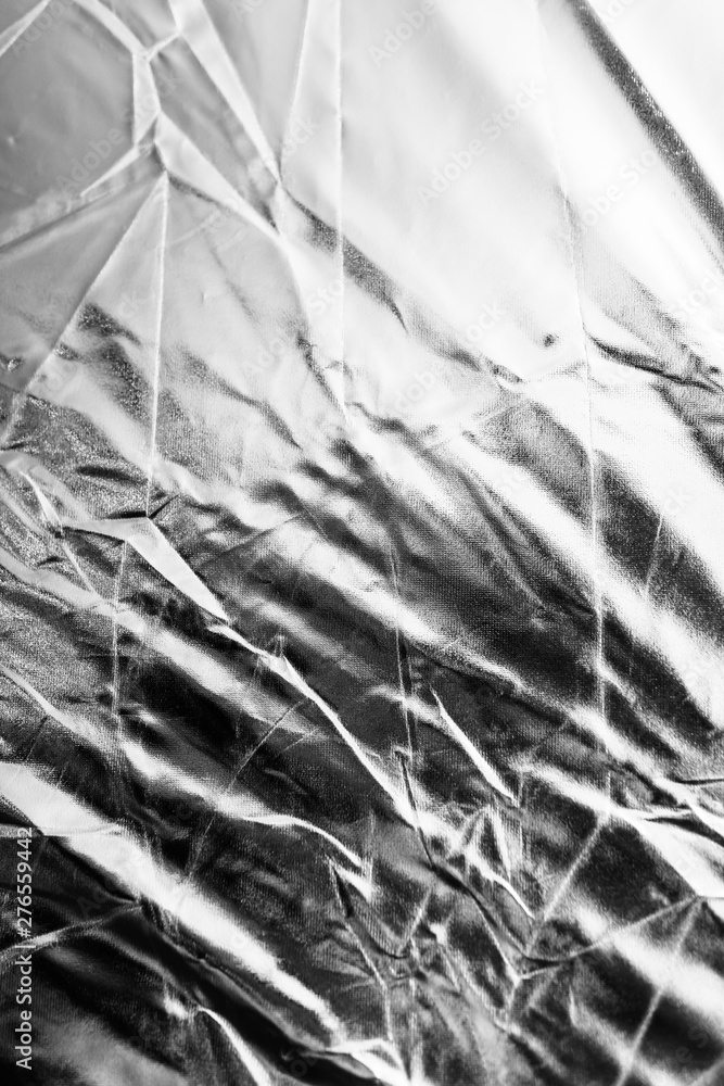 Crumpled silver material as abstract background Crumpled silver material as abstract background