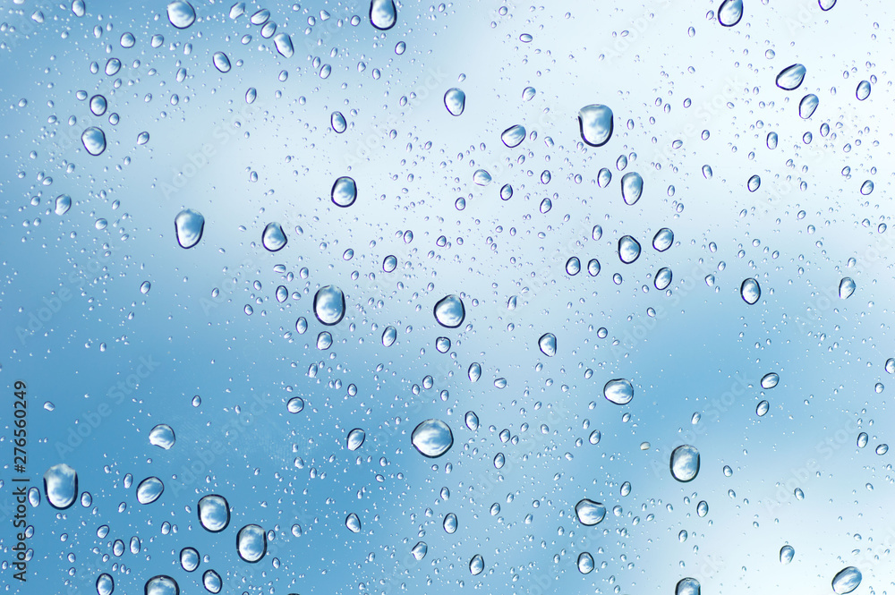 Water drops of rain on blue glass background