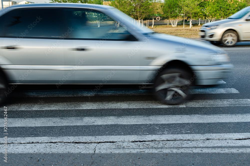 Car at high speed passes through a pedestrian Zebra. Car at high speed passes through a pedestrian Zebra.