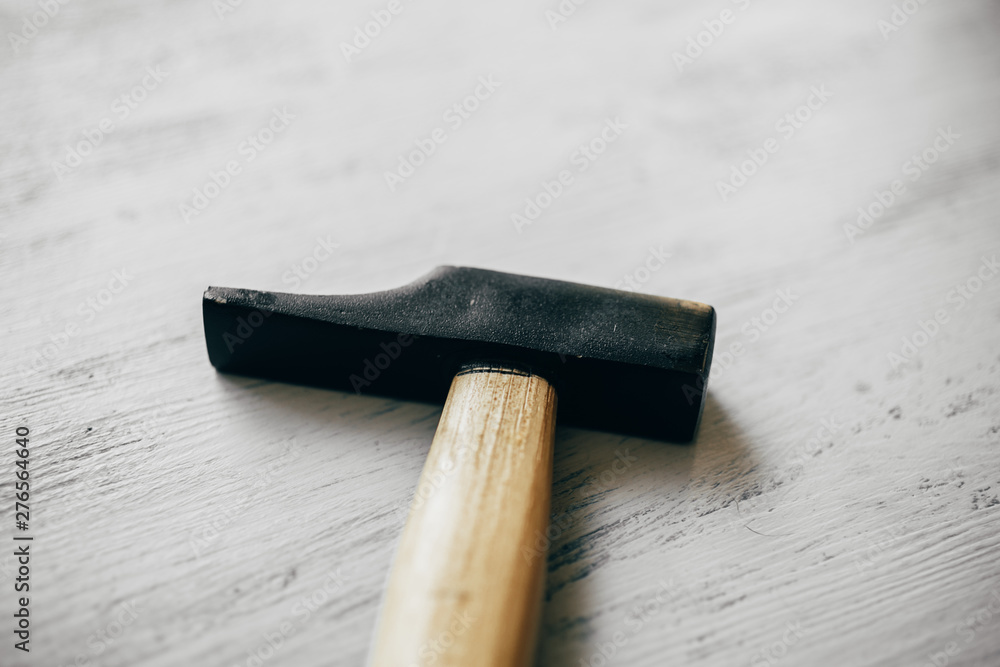 Hammer on wooden background. Construction and carpentry tools. Close up view of iron hammer with copy space.   