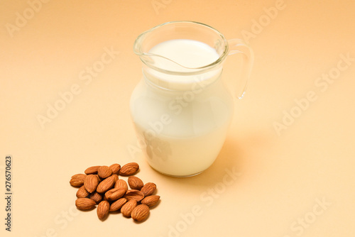 A jar with almond milk  nuts. Space for text or design.