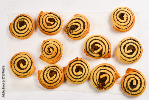Baked cookies with raisins and poppy seeds isolated on white background.