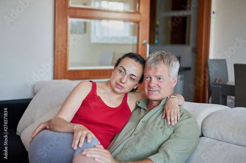 Middle-aged couple have a looking a TV at home © Arpad