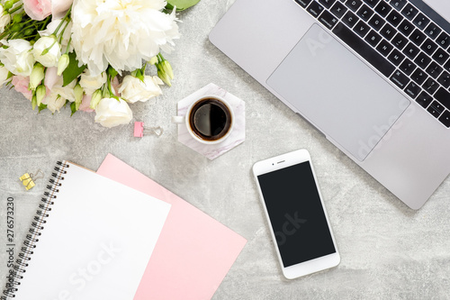 Wallpaper Mural Stylish concrete stone office desk table with laptop computer, cup of coffee, flowers, female hand writing text in paper diary notepad. Top view with copy space, flat lay. Feminine workspace concept Torontodigital.ca