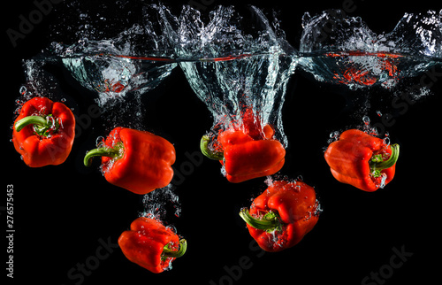 Fototapeta Water droping red bell pepper or paprika.